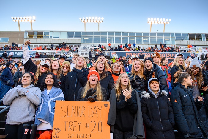 A crowd of Princeton football fans in the stands watching the football game